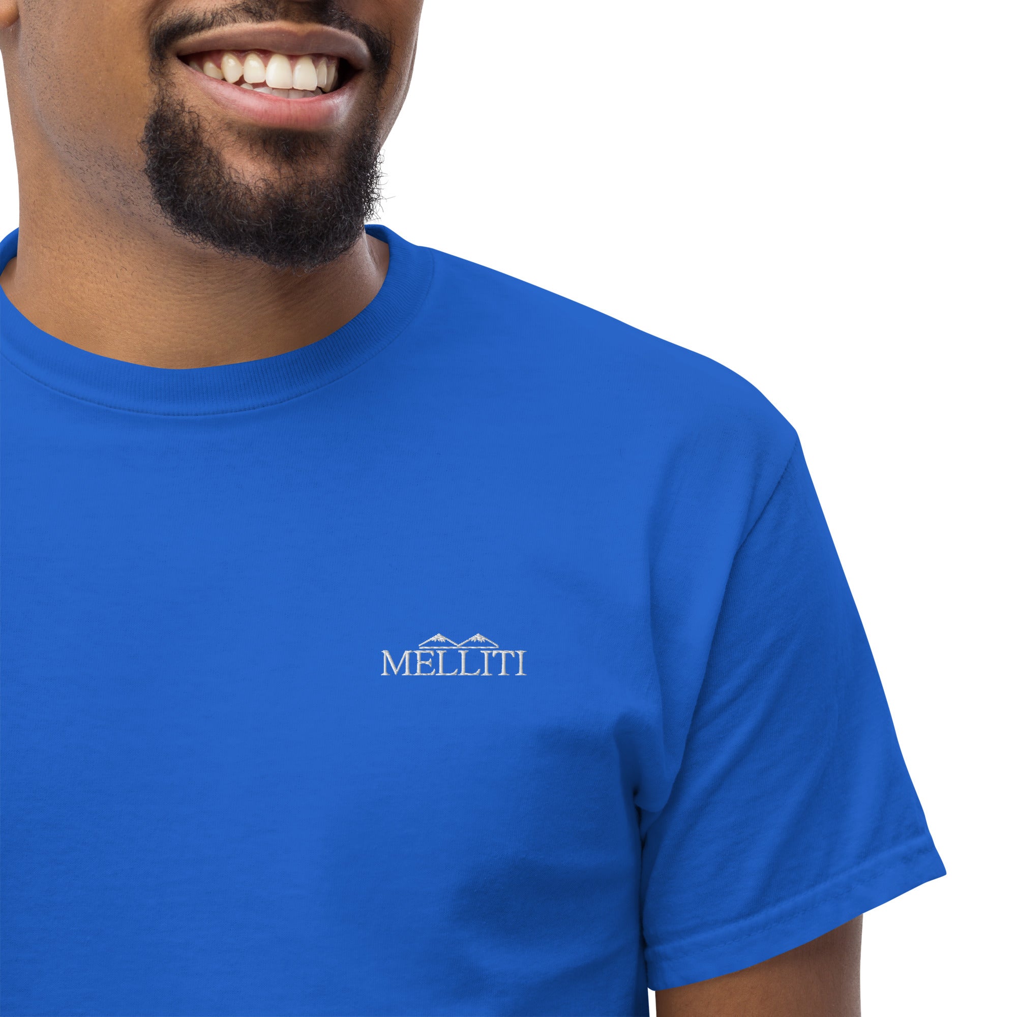 MELLITI MOUNTAINS TEE in vibrant blue worn by a smiling model, showcasing a stylish and structured look.